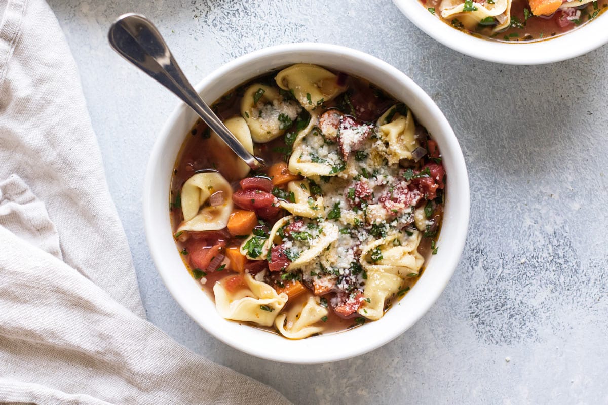 overhead photo of a bowl of tortellini soup.