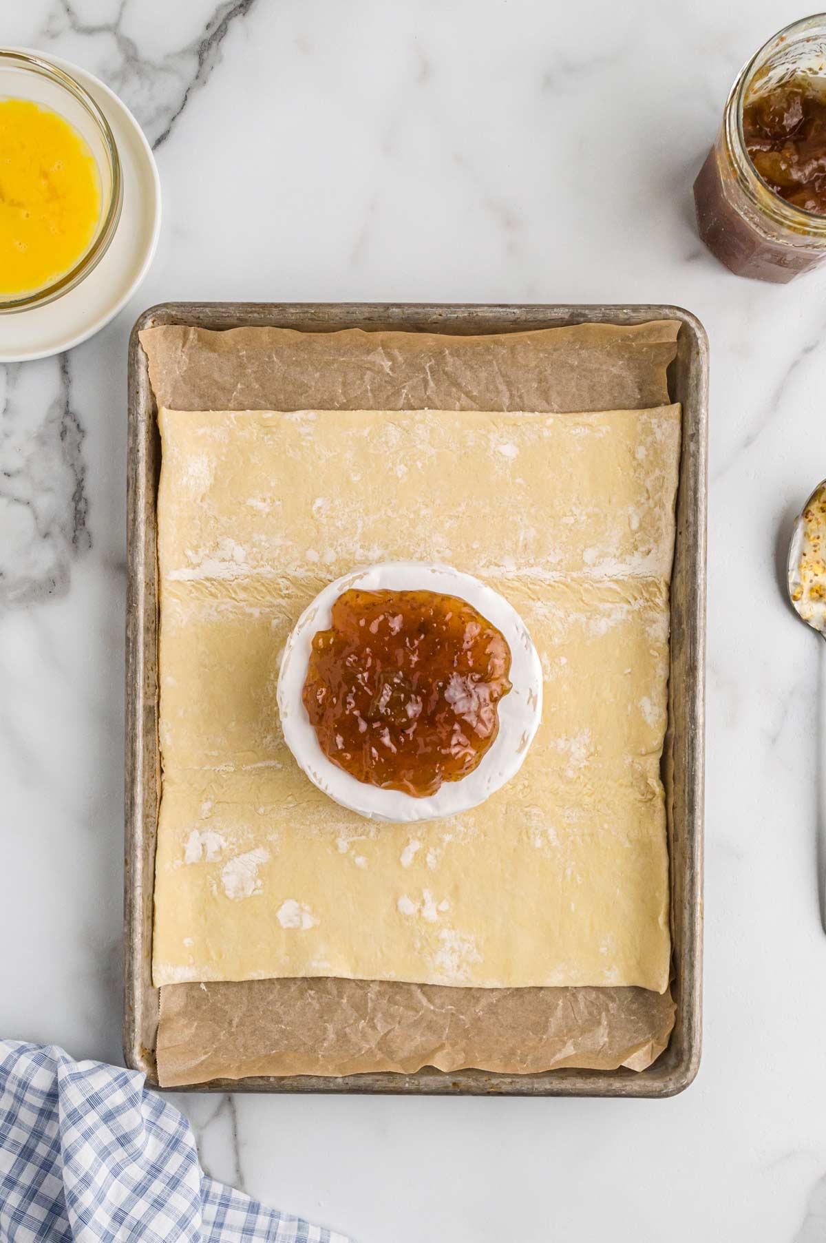 brie round on puff pastry and topped with jam.