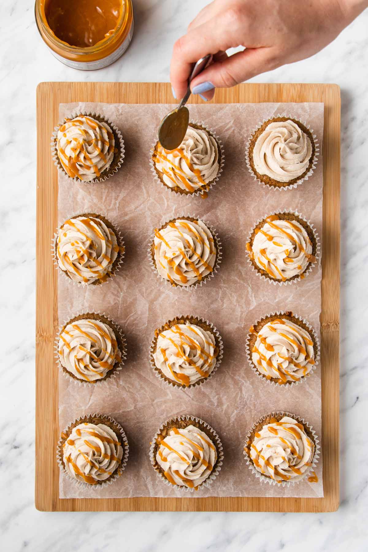 overhead shot of caramel being drizzled on the frosting.