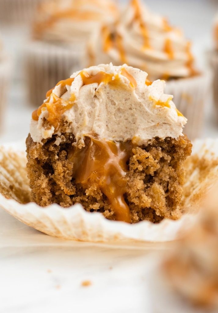 a cupcake sliced in half with caramel oozing out.