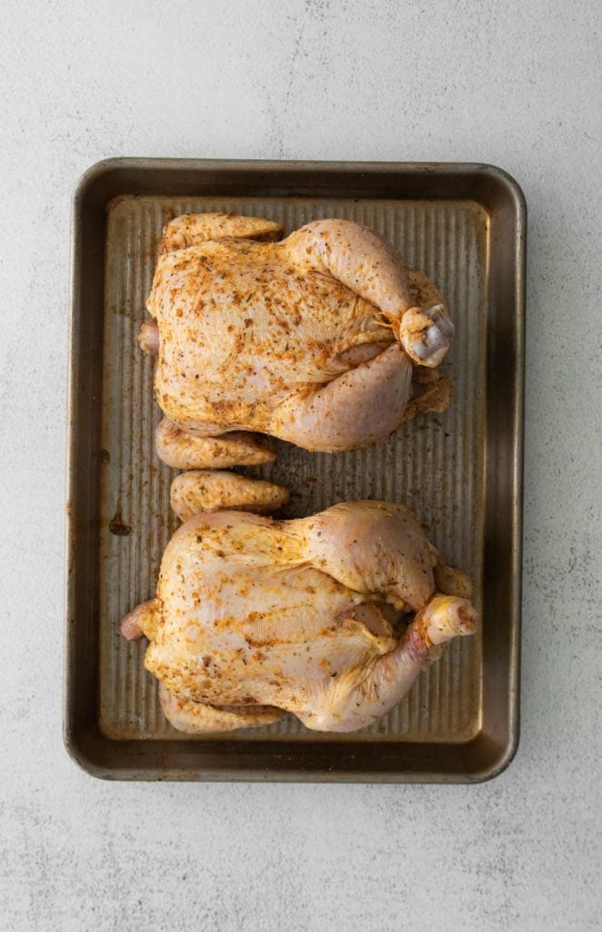 overhead photo of the hens on a pan coated with spices.