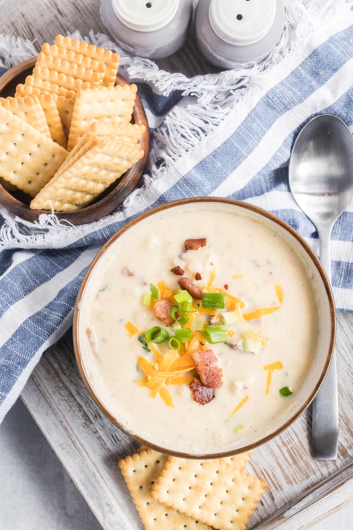 a bowl of soup with crackers on the side.