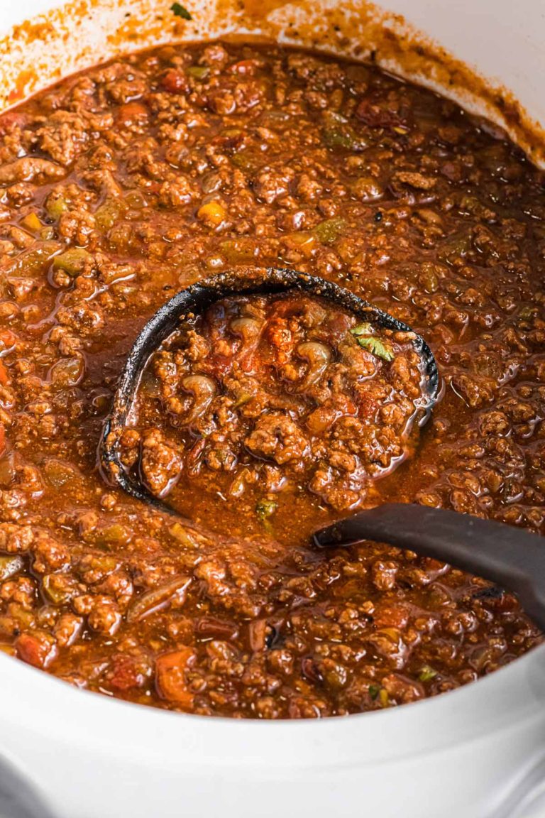 chili in a slow cooker with a ladle.