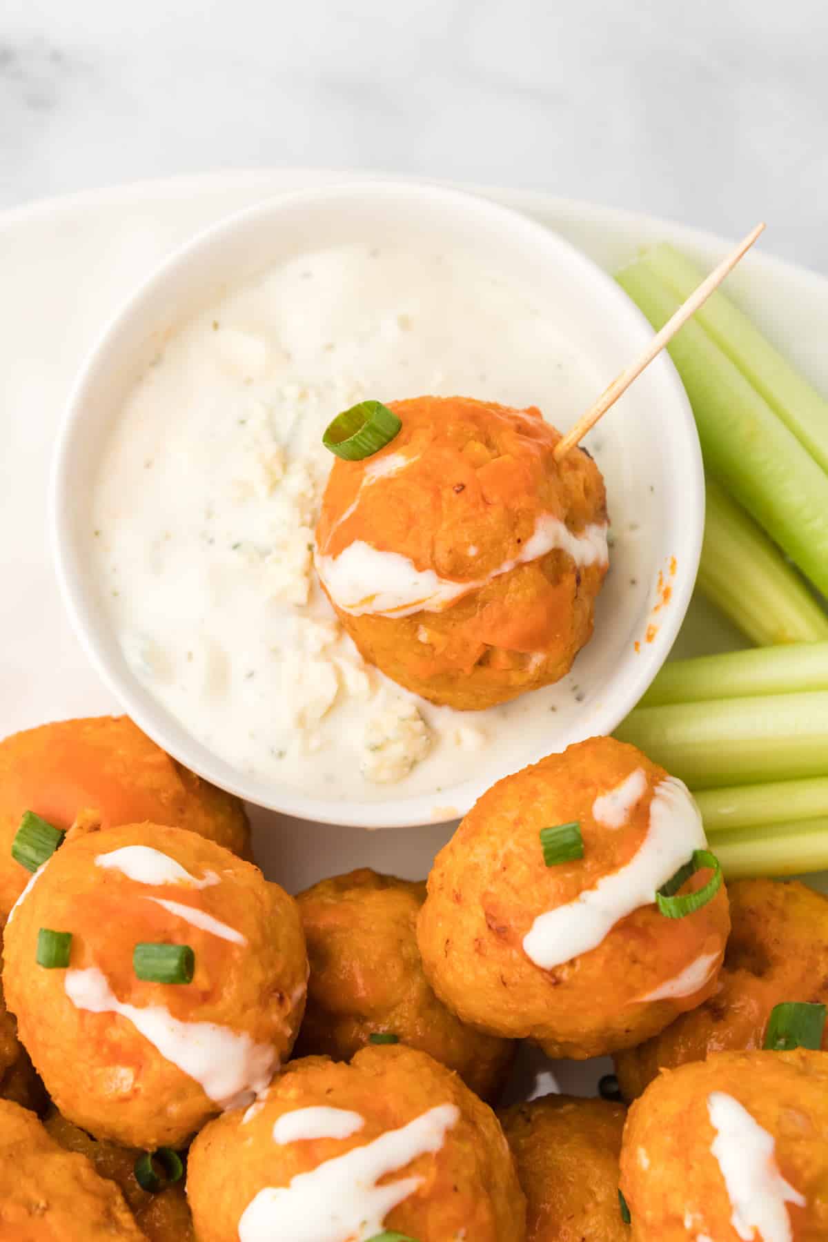 a meatball dipped in blue cheese dip.