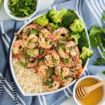 honey garlic shrimp in a bowl with rice and broccoli.