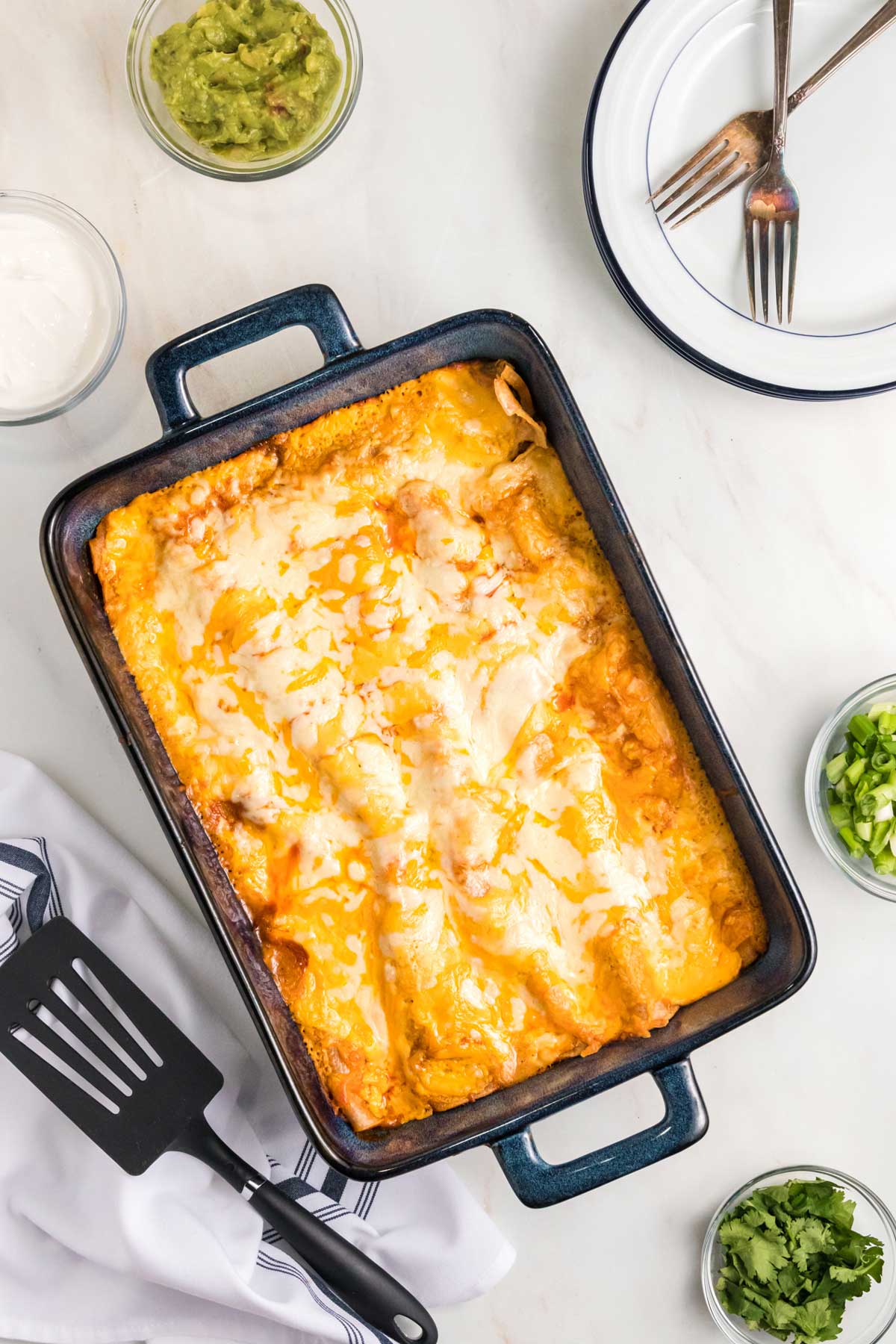 overhead shot of baked enchiladas in a pan.