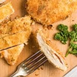 overhead shot of a piece of baked chicken on a fork.