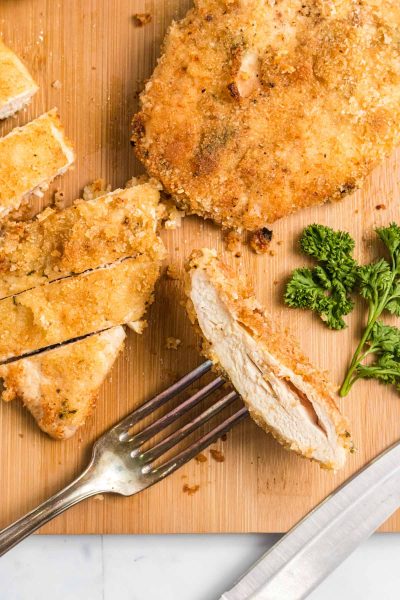 overhead shot of a piece of baked chicken on a fork.