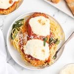 overhead shot of a plate of chicken parmesan with pasta.