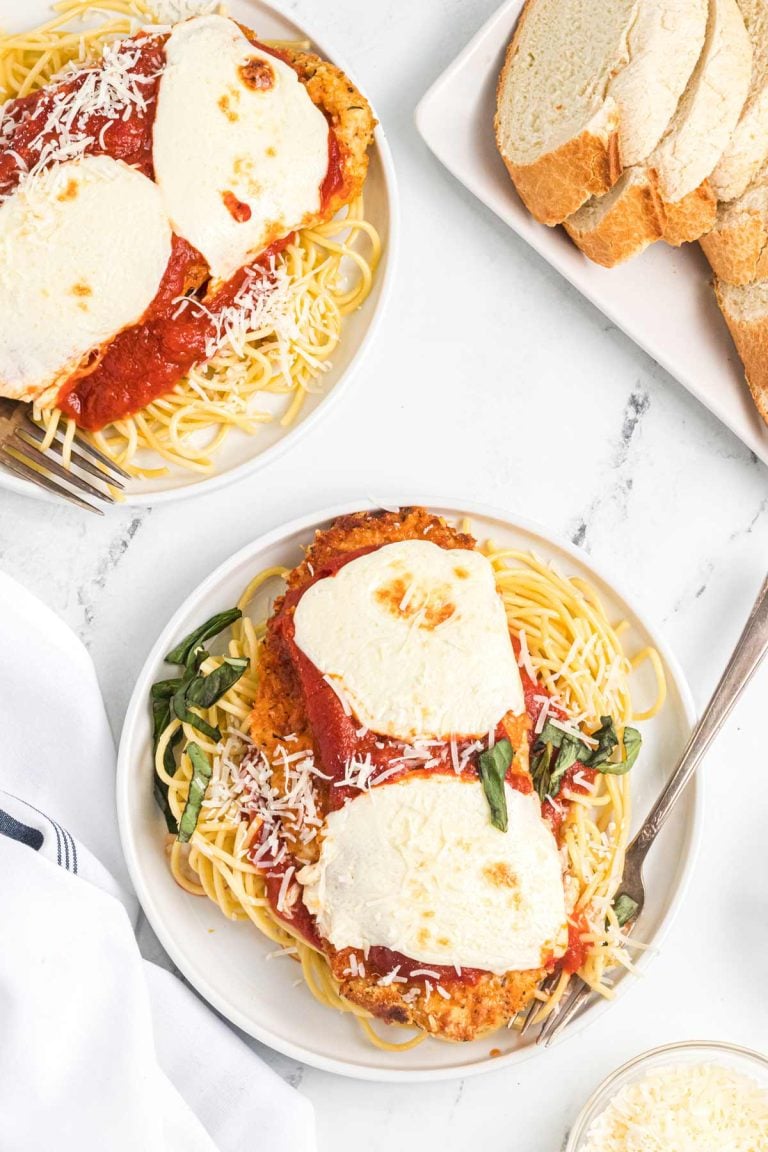 overhead shot of the chicken parm on plates ready to serve.,