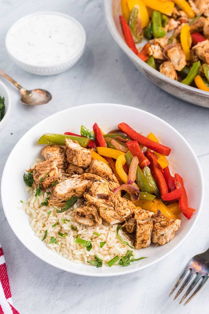 chicken fajitas in a bowl with rice.