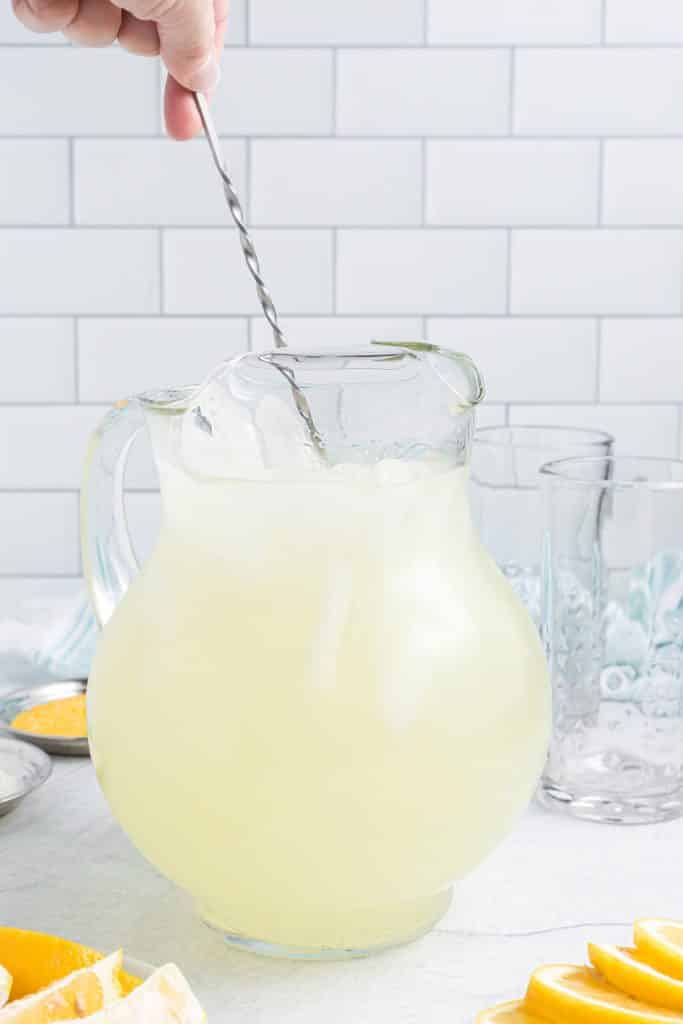 lemonade with vodka being stirred in a pitcher.