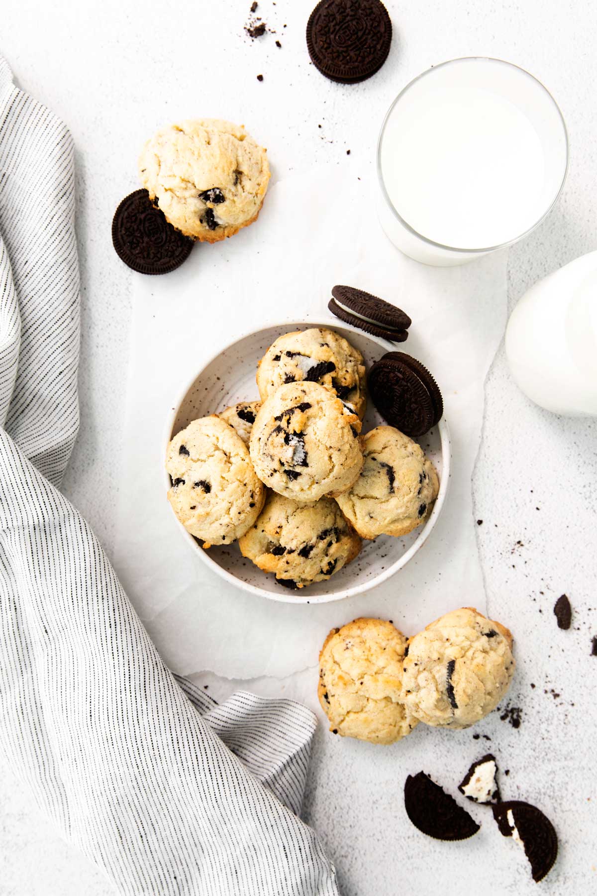 cookies in a bowl with a glass of milk.