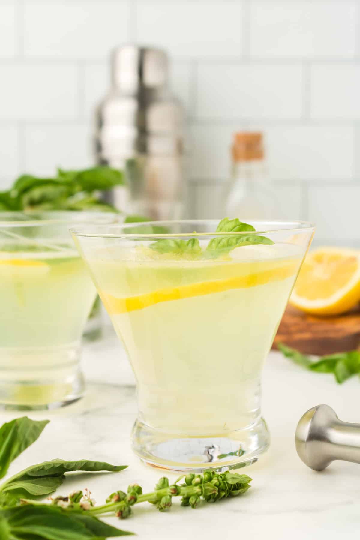 a glass of lemon basil cocktail.
