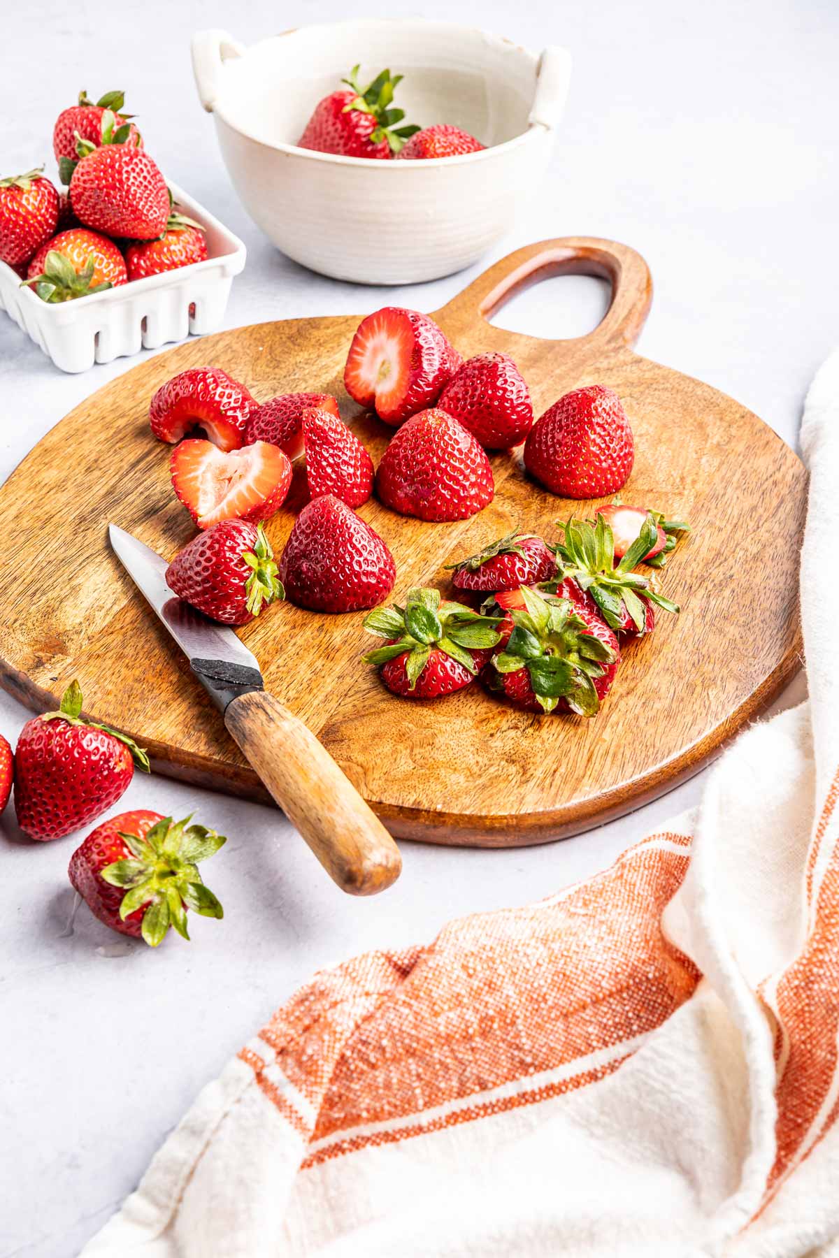 strawberries on a cutting board.