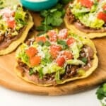 close-up shot of the finished tostadas on a wood platter.
