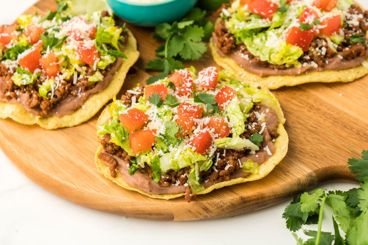 close-up shot of the finished tostadas on a wood platter.