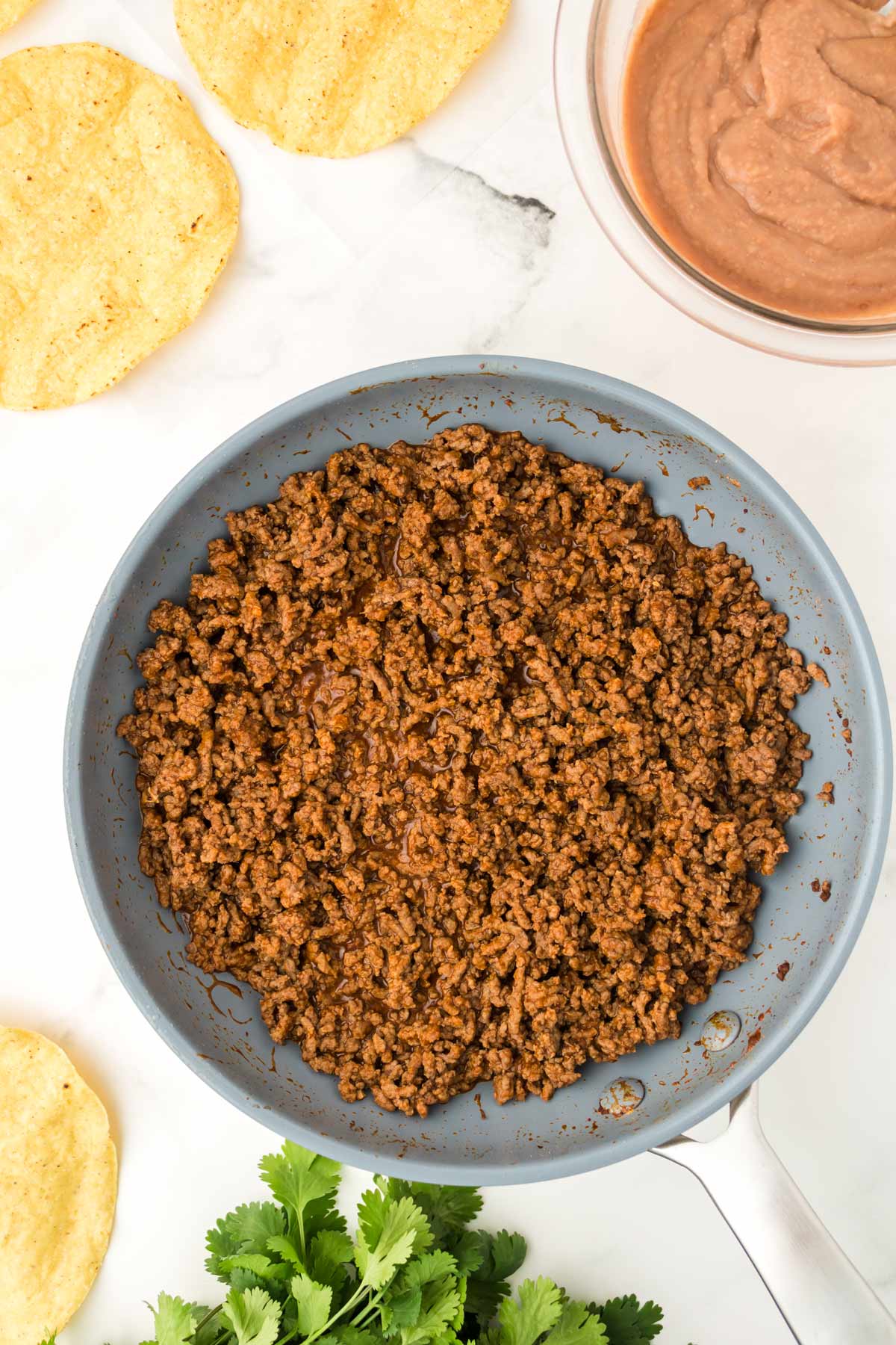 seasoned ground beef in a pan.