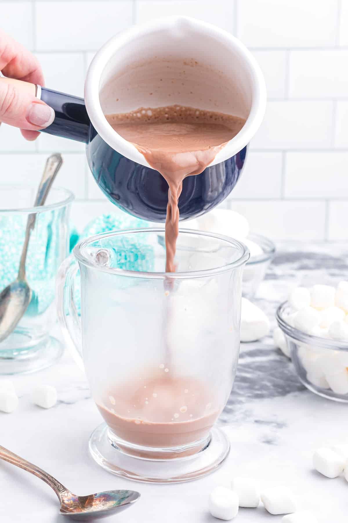 hot chocolate being poured into a mug.