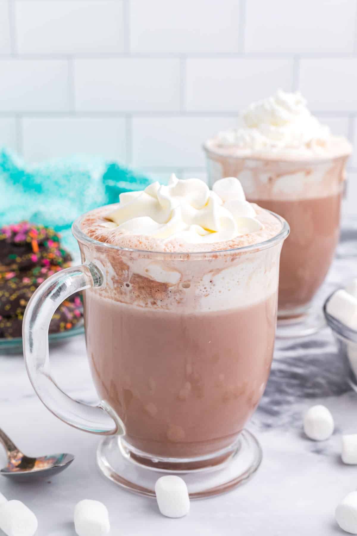 a mug of hot chocolate topped with whipped cream.