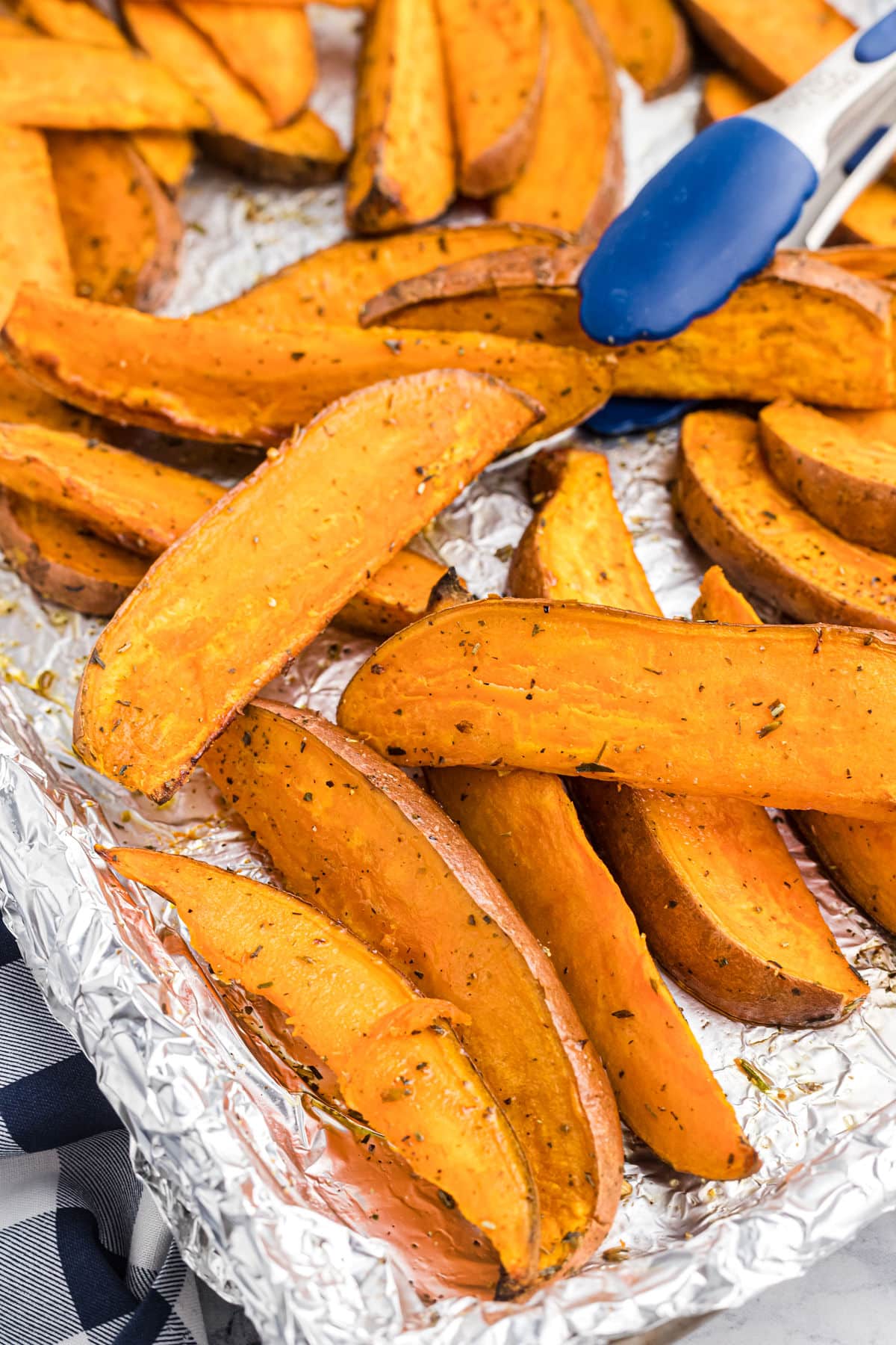 potato wedges on a sheet pan lined with foil.