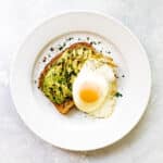 avocado toast with an egg on top.