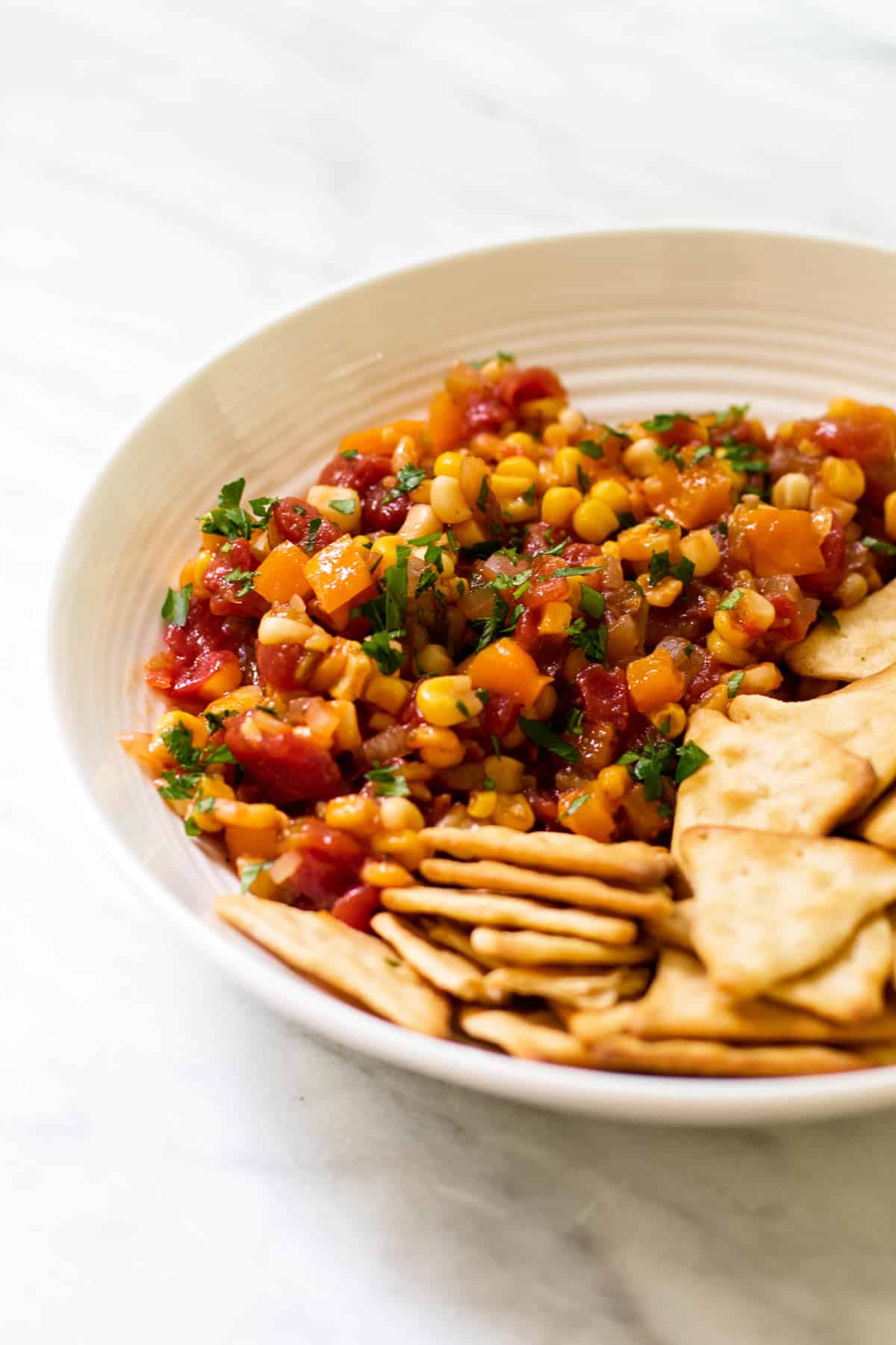 corn relish in a bowl with crackers.