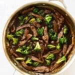 beef and broccoli in a skillet.