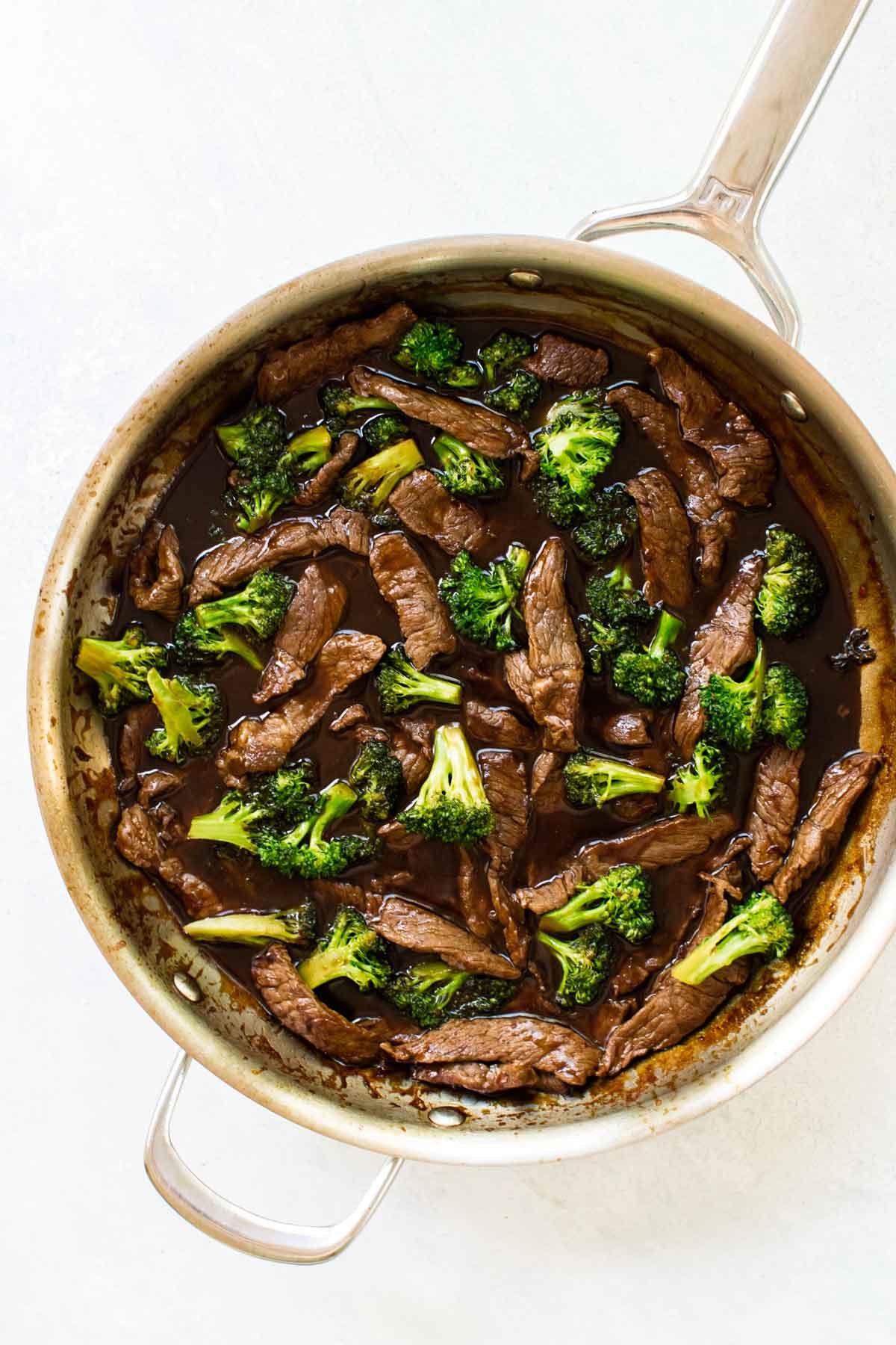 beef and broccoli in a skillet.