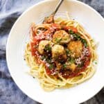 a bowl of turkey meatballs with sauce and pasta.