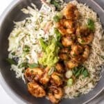 shrimp, rice, and coleslaw in a bowl.