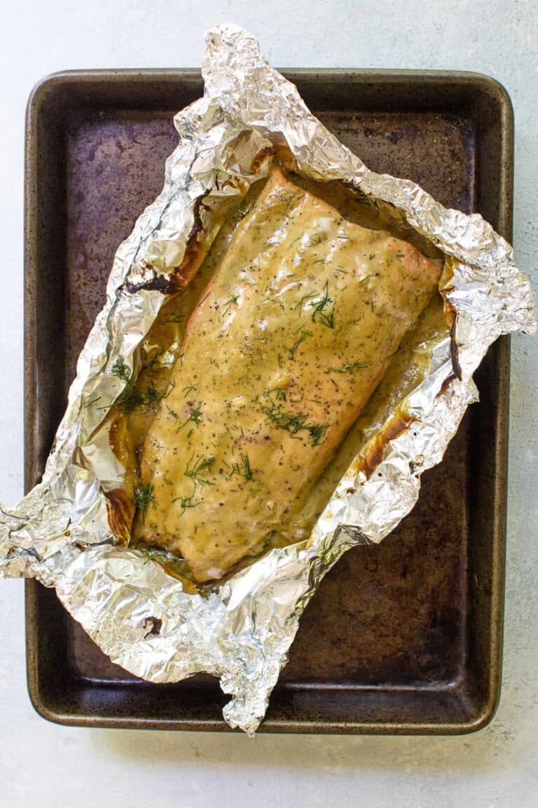 honey mustard salmon in foil on a sheet pan.