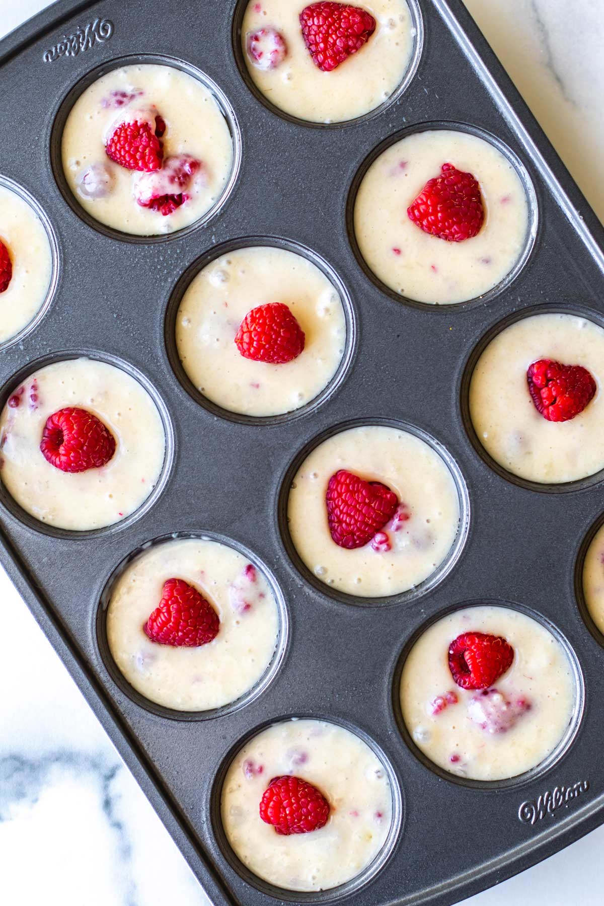 the batter in a pan and topped with raspberries.