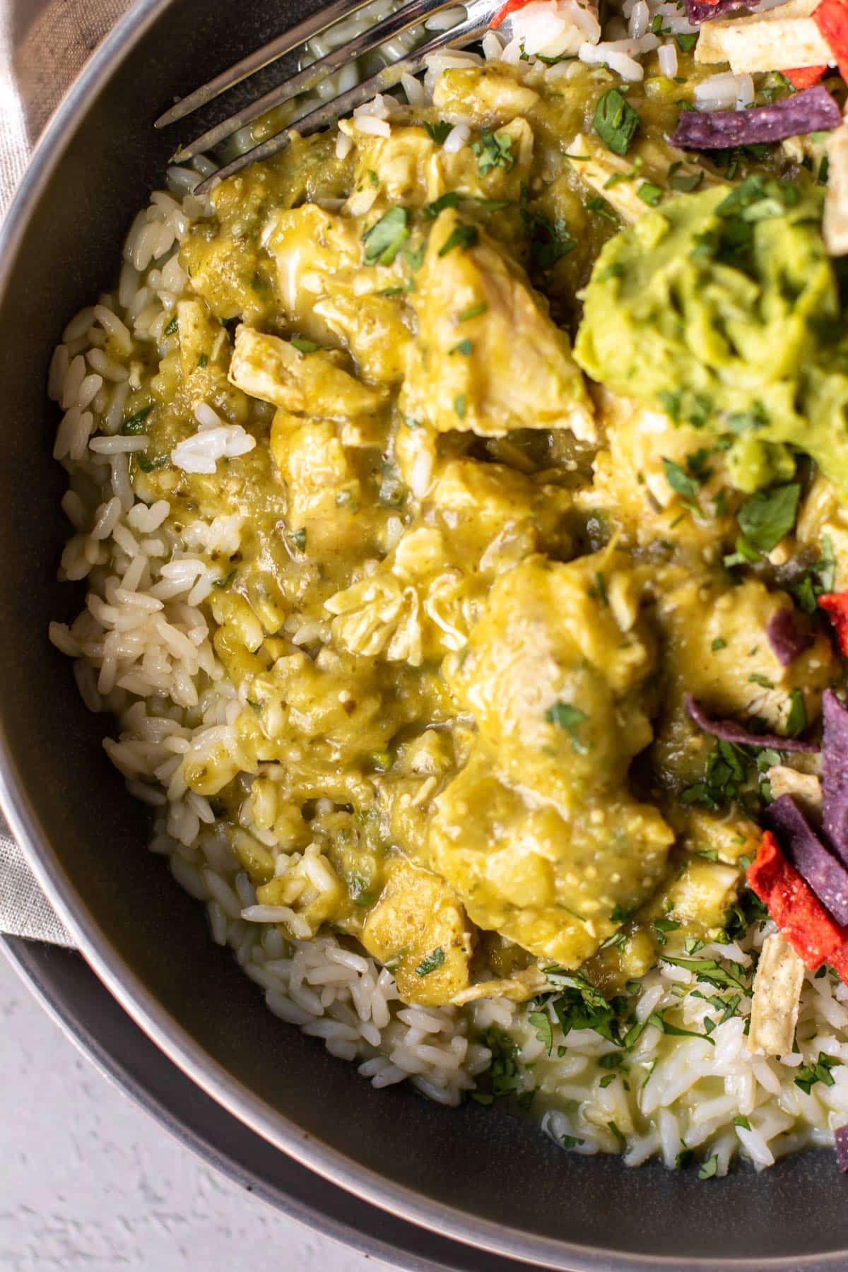 salsa verde chicken in a bowl with rice.