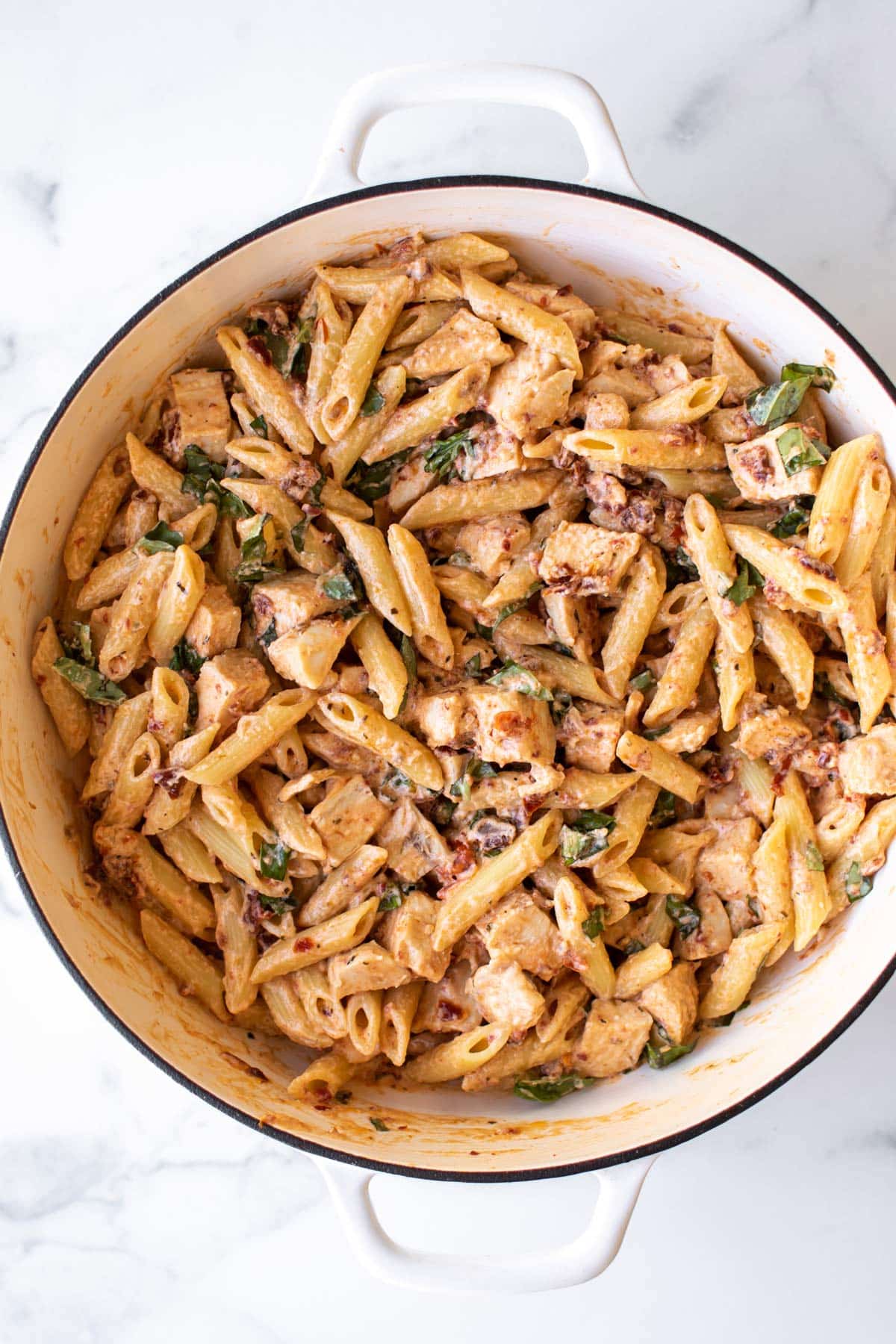 the pasta and chicken added to the pan.