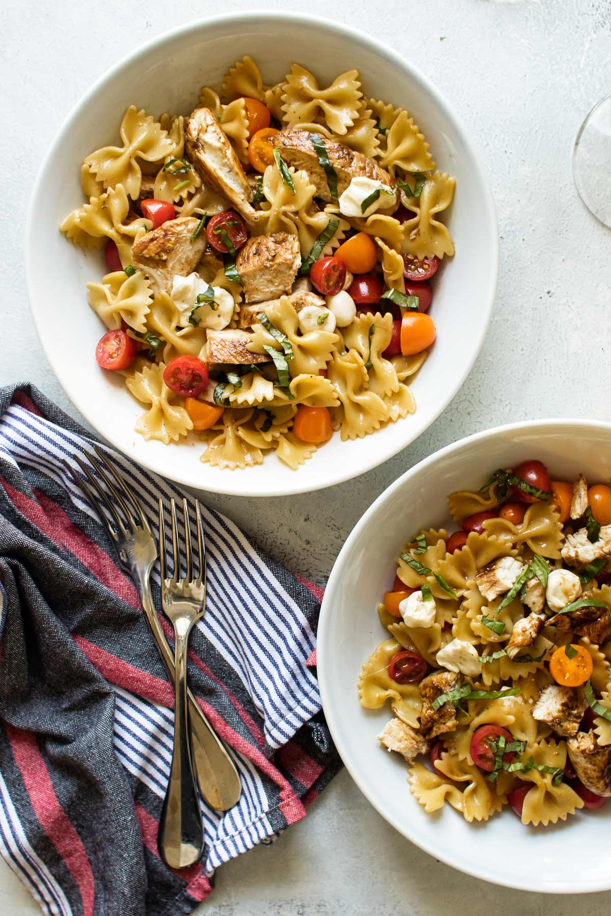 two bowls of caprese chicken pasta.