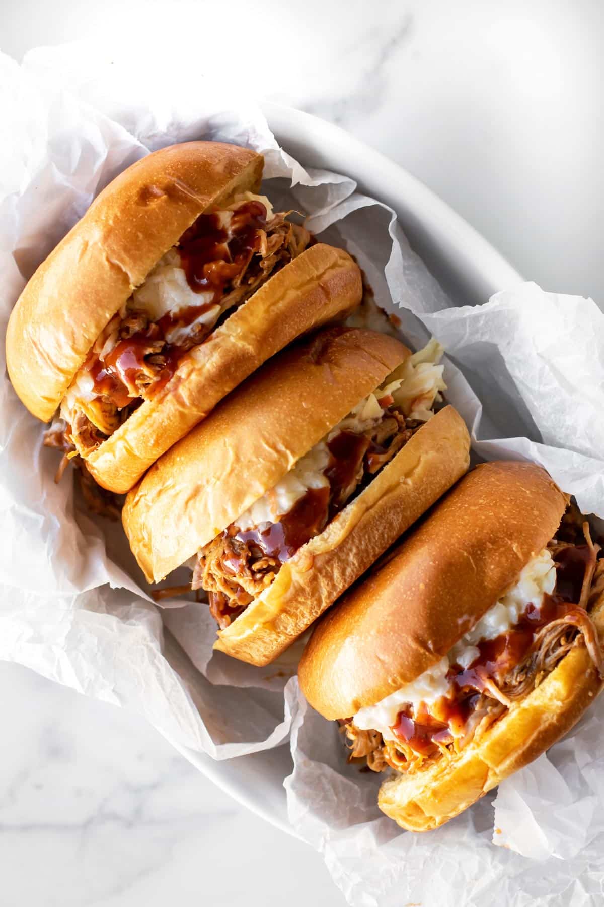 https://www.girlgonegourmet.com/wp-content/uploads/2023/05/Pulled-Pork-Sandwiches-1.jpg