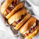 three pork sandwiches with coleslaw.