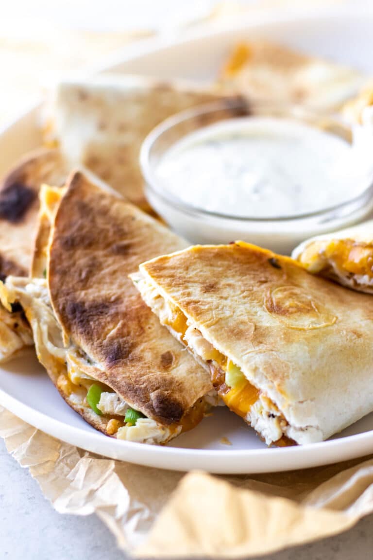 quesadillas on a plate with ranch dressing.