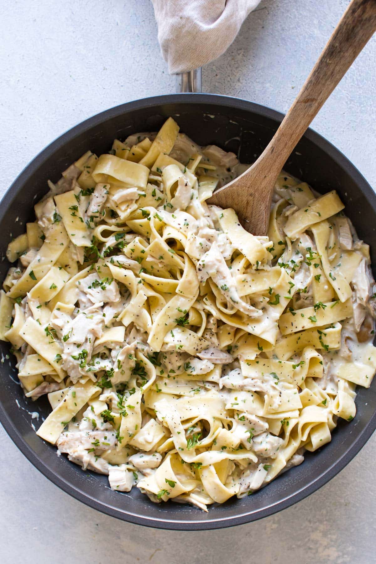 creamy chicken and noodles in a pan.