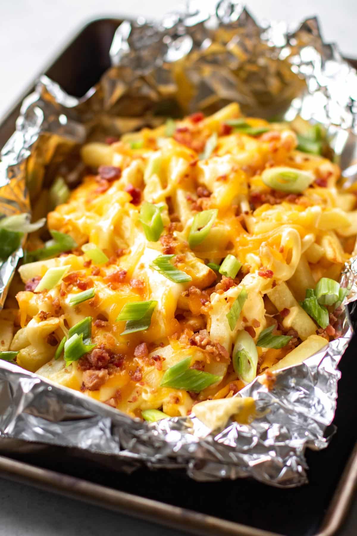 a pan of loaded cheese fries.