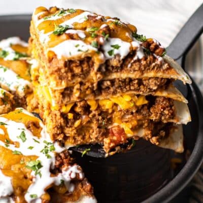 a piece of taco pie being lifted from the pan.