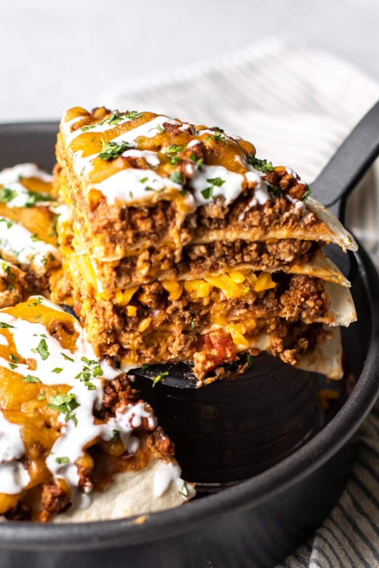 a piece of taco pie being lifted from the pan.