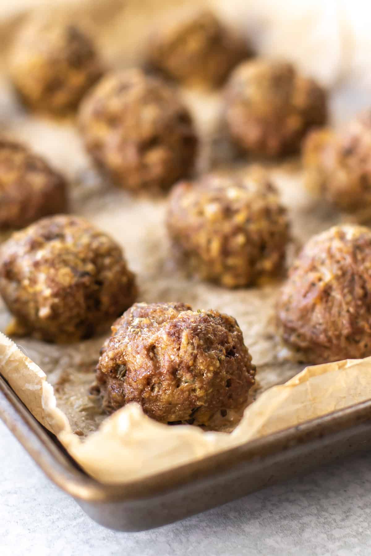 baked meatballs on a sheet pan.