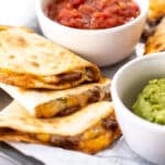 pieces of quesadilla with dips.