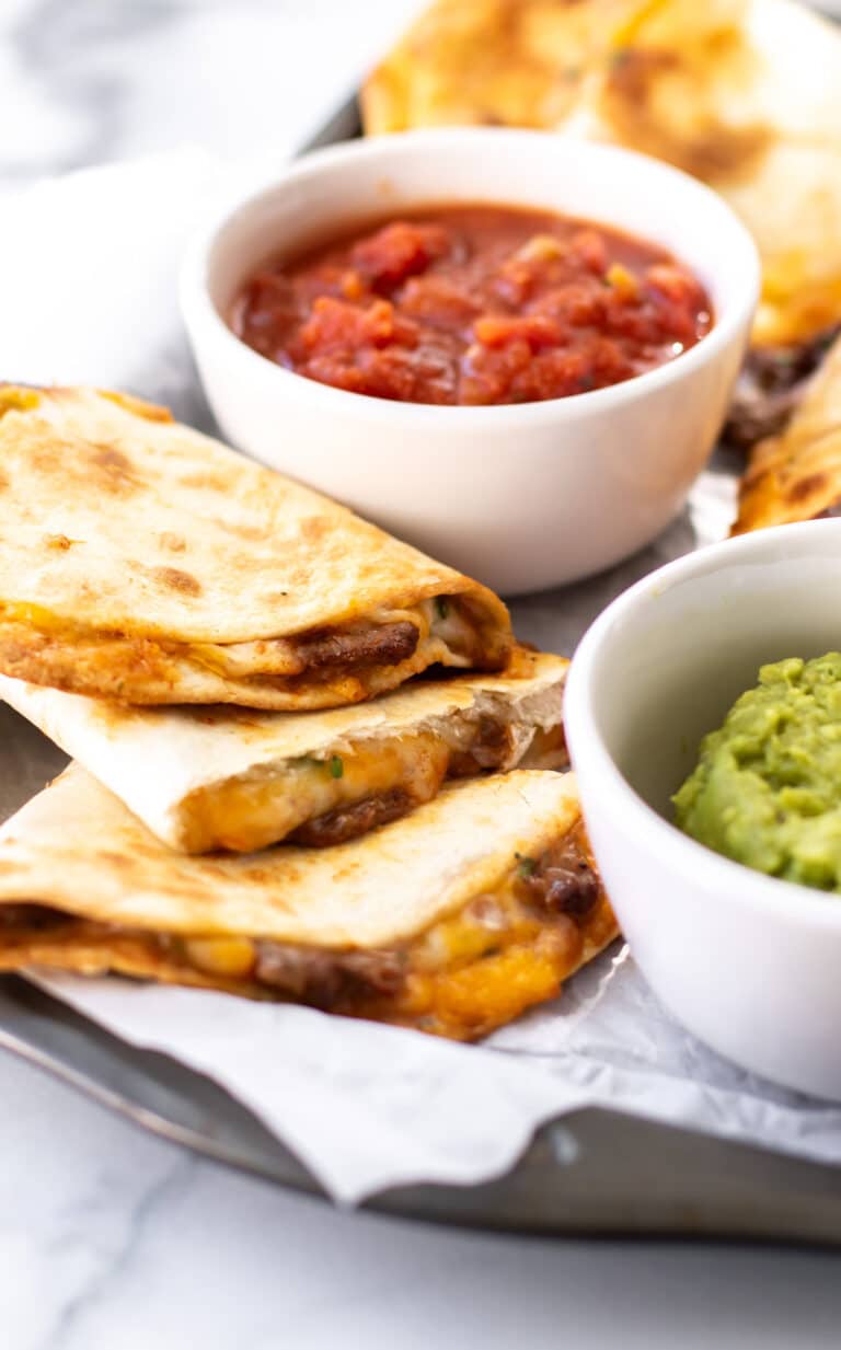 pieces of quesadilla with dips.