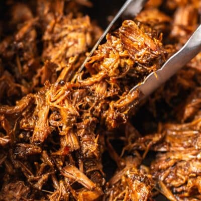 close-up shot of shredded beef in a slow cooker.