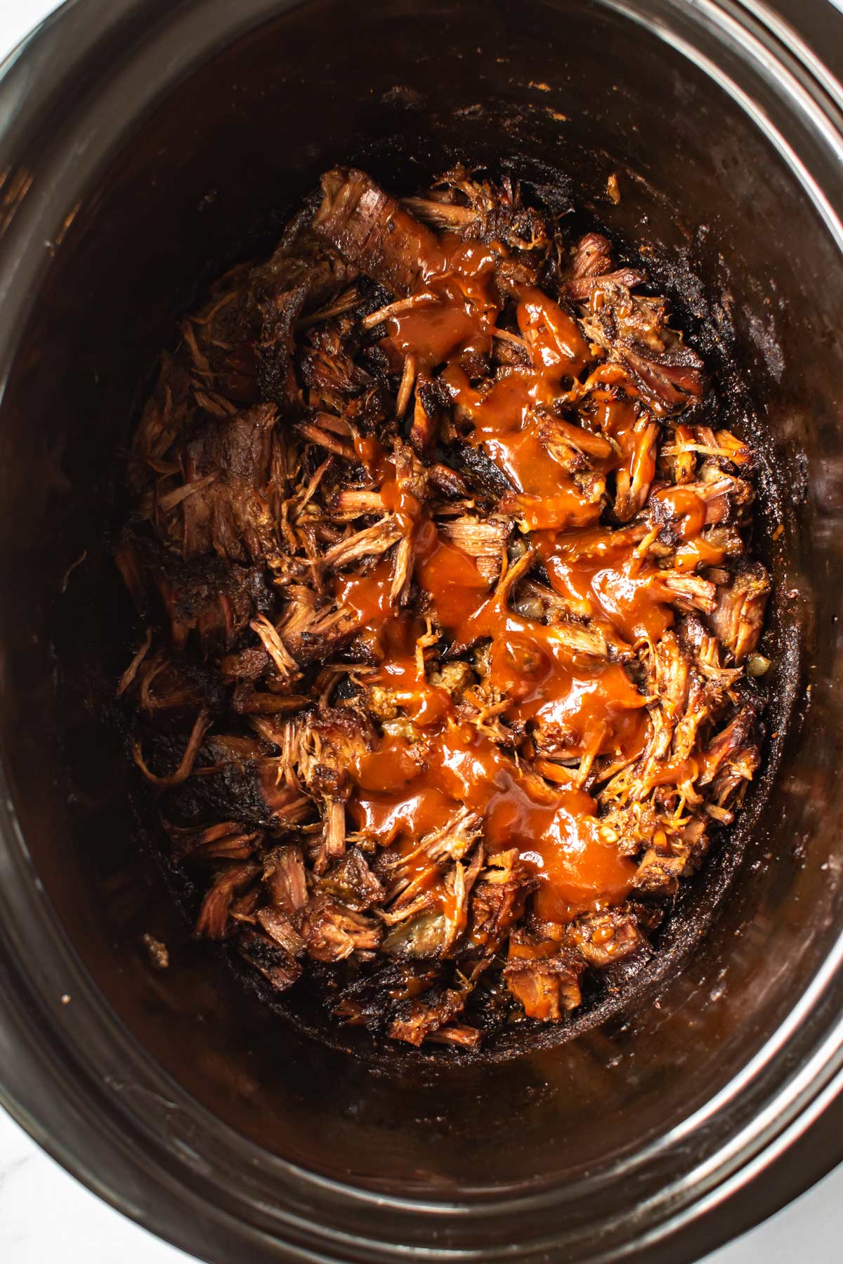 bbq sauce poured over the shredded beef.