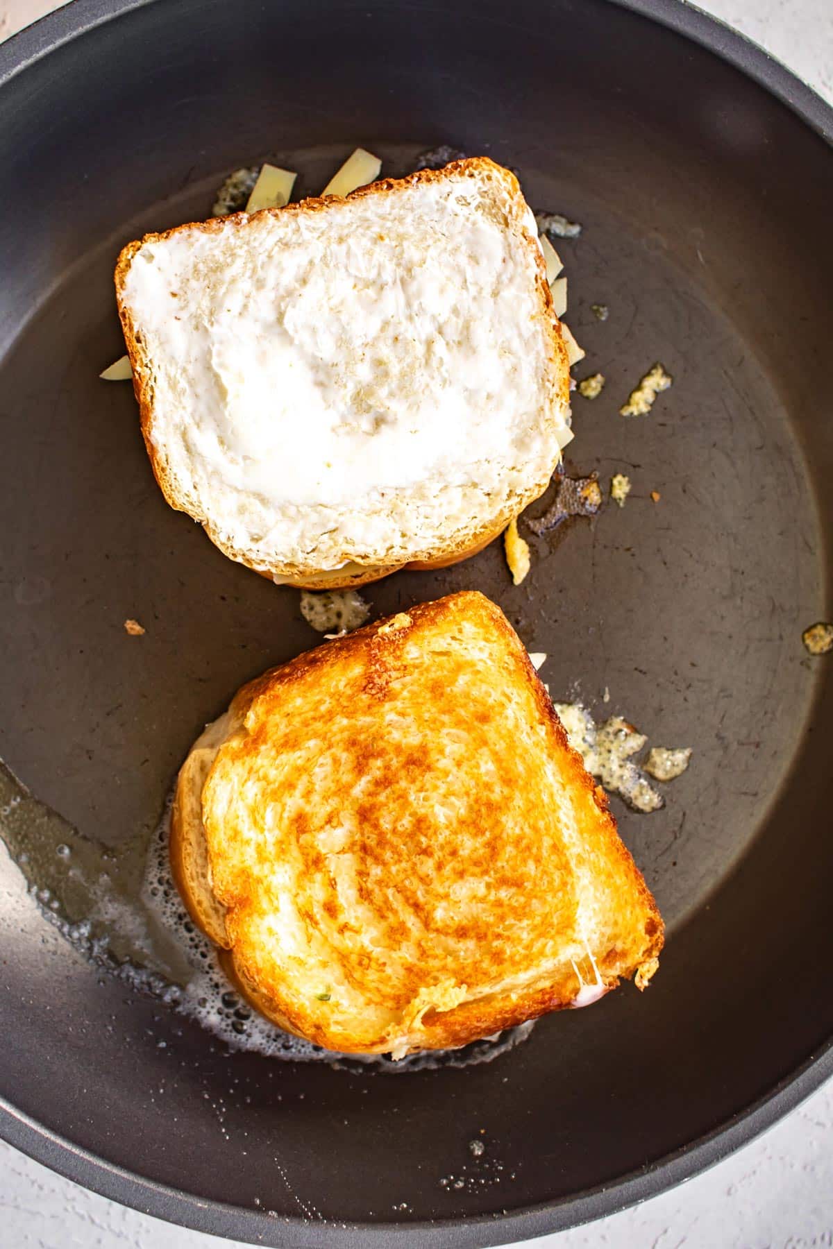 grilled cheese sandwiches in a pan.