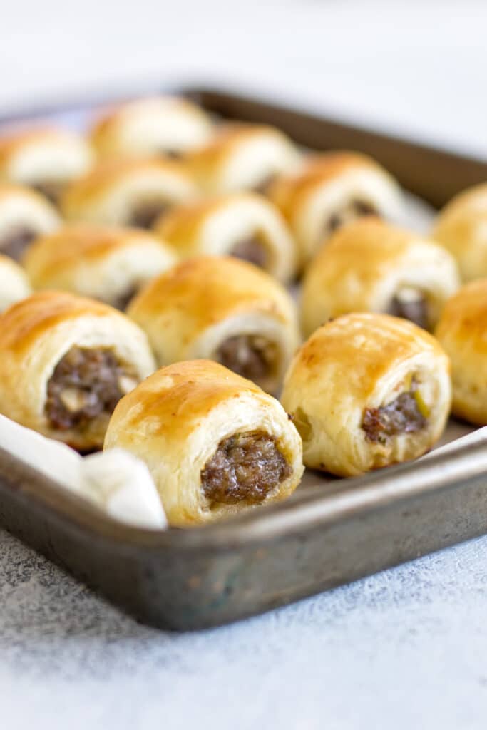 baked sausage rolls on a baking sheet.